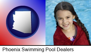 Phoenix, Arizona - a little girl wrapped in a dark red towel, in front of a swimming pool