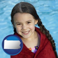 pennsylvania map icon and a little girl wrapped in a dark red towel, in front of a swimming pool