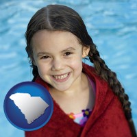 south-carolina map icon and a little girl wrapped in a dark red towel, in front of a swimming pool