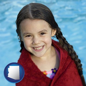 a little girl wrapped in a dark red towel, in front of a swimming pool - with Arizona icon