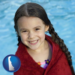 a little girl wrapped in a dark red towel, in front of a swimming pool - with Delaware icon