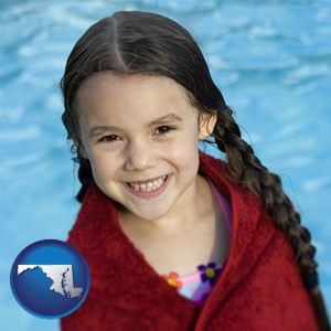 a little girl wrapped in a dark red towel, in front of a swimming pool - with Maryland icon