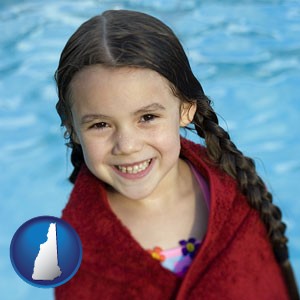 a little girl wrapped in a dark red towel, in front of a swimming pool - with New Hampshire icon