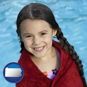 a little girl wrapped in a dark red towel, in front of a swimming pool - with Pennsylvania icon