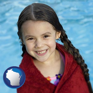 a little girl wrapped in a dark red towel, in front of a swimming pool - with Wisconsin icon