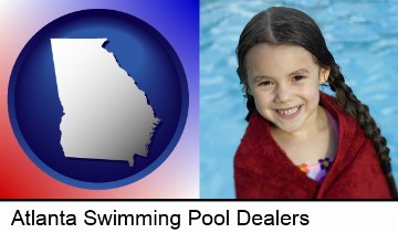 a little girl wrapped in a dark red towel, in front of a swimming pool in Atlanta, GA