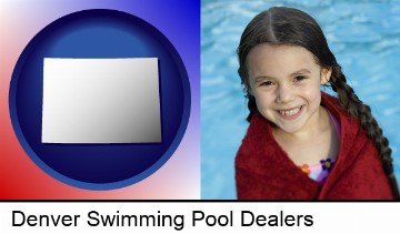 a little girl wrapped in a dark red towel, in front of a swimming pool in Denver, CO