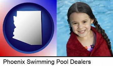 a little girl wrapped in a dark red towel, in front of a swimming pool in Phoenix, AZ