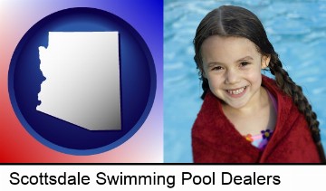 a little girl wrapped in a dark red towel, in front of a swimming pool in Scottsdale, AZ